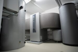 White air source heat pump unit mounted on an exterior wall